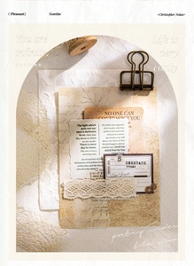 Detail of vintage scrapbooking kit with antique newspaper fragments and lace trims