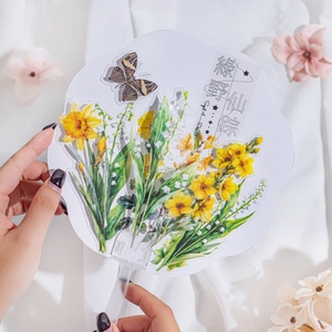Floral PET sticker featuring yellow narcissus and butterfly on a clear round fan
