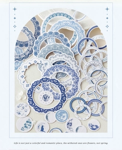 Macro shot of blue lace frames and moon phase stickers for vintage scrapbooking