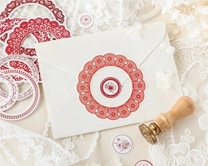 Macro shot of vintage red lace round stickers on envelope with elegant wax seal
