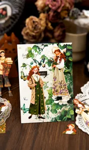 Close-up of vintage aesthetic stickers with figure and floral motifs for journaling