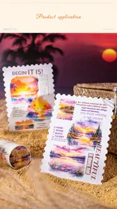 Close-up of Sunset Afterglow washi tape and scenic stamp-style cards on a sandy beach