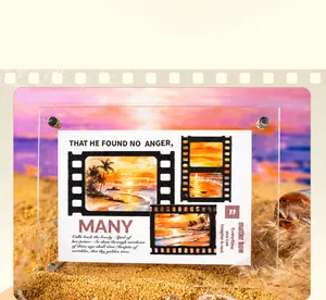 Acrylic frame with sunset beach card on sand against a purple sky background