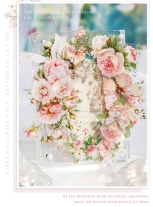 Detail of 3D pink roses, butterflies and pearl embellishments on a clear acrylic frame