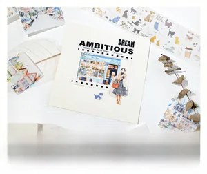 Macro detail of watercolor building and cat stickers for DIY scrapbooking projects