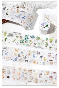 Macro detail of decorative washi tape rolls with cat and plant illustration patterns