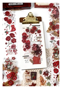 Close-up of vintage PET floral stickers with red roses and berries for DIY scrapbooking