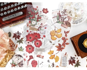 Close-up of vintage PET floral stickers featuring red berries and autumn ginkgo leaves
