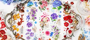 Detail of vintage floral PET stickers featuring hydrangeas and maple leaves on a silver tray