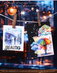Artistic watercolor PET stickers showing a lady with umbrella in rain on a wooden clip