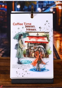 Vertical art calendar with gold clip featuring rainy day watercolor illustrations on wood