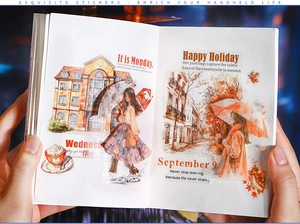 Close-up of PET stickers with watercolor girls and umbrellas on a notebook planner