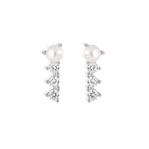 Detailed view of silver stud earrings featuring white pearls and three vertical cubic zirconias