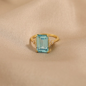 Elegant gold S925 silver ring with emerald-cut blue zircon and side diamond accents