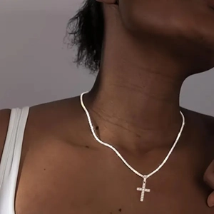 Elegant S925 sterling silver sparkling cross necklace on a female model neck