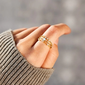Three-piece gold S925 silver ring set featuring a floral opal center and micro-pave accents