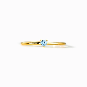 Minimalist S925 sterling silver ring with heart-shaped blue gemstone and gold-plated band