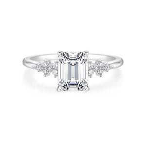 Front view of emerald cut zircon ring with micro-pave side stones on silver band