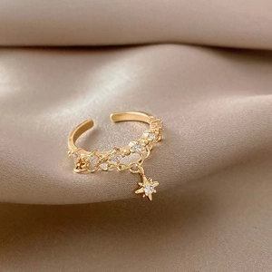 Adjustable gold star ring with cubic zirconia fringe pendant and sparkling pavé accents