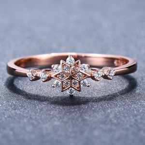 Elegant S925 rose gold snowflake ring with white zircon stones on a grey background