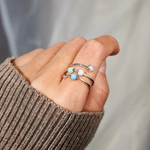 Detail of three-layer S925 silver spinning rings with colorful opal beads and zircon