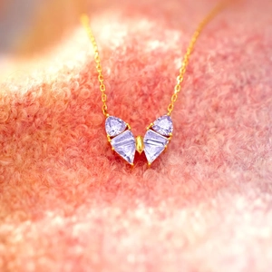 Elegant gold S925 silver necklace featuring a purple zircon butterfly pendant on soft fabric