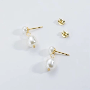 Detailed view of s925 sterling silver drop earrings with elegant baroque white pearls