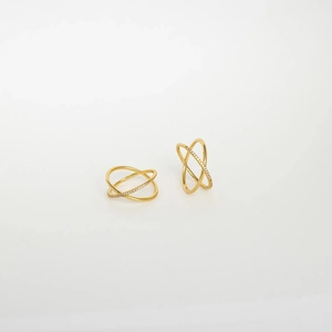 Double-layered crossed gold hoop earrings with sparkling cubic zirconia on white background
