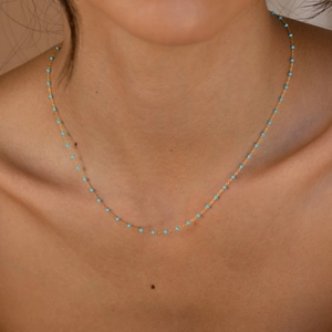 Minimalist S925 sterling silver gold plated necklace with blue enamel beads on a model