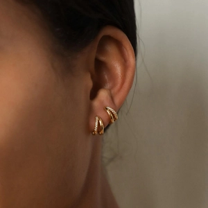 Elegant gold double hoop earrings for women with paved zircon on model's ear