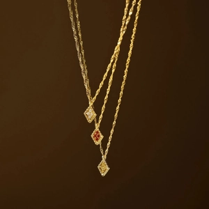 Three gold rope chain necklaces with diamond-shaped birthstone pendants in a row