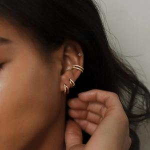 Detailed view of model wearing minimalist gold S925 silver hoop earrings with white zircon