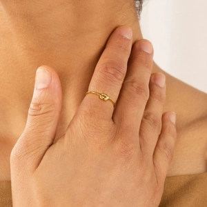 Minimalist s925 gold heart knot ring shown on model for a trendy chic style