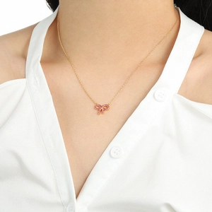 Elegant s925 silver bow necklace with pink pavé stones worn by a model in white shirt