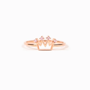Elegant rose gold crown ring for women featuring four sparkling pink gemstones on a white background