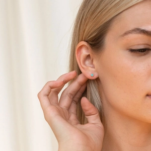 Minimalist S925 sterling silver turquoise stud earrings with gold plating on female ear