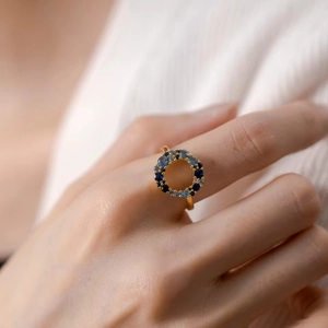 Elegant gold S925 silver ring featuring blue gradient zircon stones on index finger