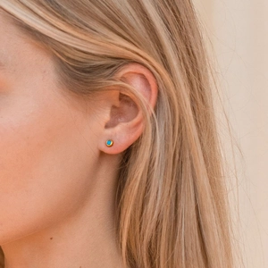 Elegant s925 silver round turquoise stud earrings in gold plating worn by a model