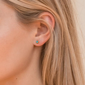 Minimalist S925 silver turquoise stud earrings in gold finish on a female model
