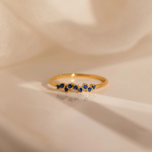 Elegant s925 gold-plated sterling silver wave ring with blue zircon birthstones