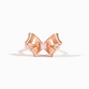 Elegant rose gold matte bow ring with square gemstone inlay on a clean white background