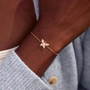 Elegant gold S925 sterling silver bracelet with pink zircon butterfly charm on wrist