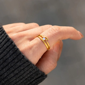Minimalist S925 sterling silver gold wave ring with blue moonstone worn on finger