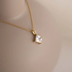Elegant gold S925 sterling silver necklace featuring a square zircon pendant on mannequin