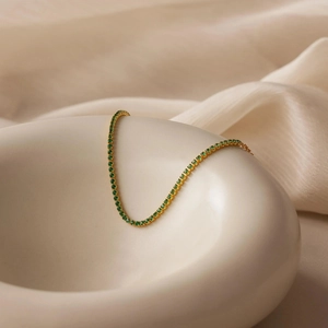 Elegant gold plated S925 silver tennis bracelet with green round cut cubic zirconia