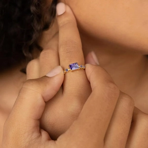 Elegant gold S925 silver ring featuring a rectangular purple gemstone with blue side stones