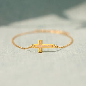 Elegant gold cross bracelet for women with horizontal pink opal stone and adjustable chain