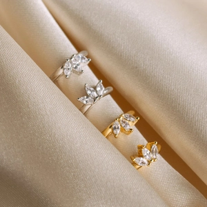 Elegant s925 silver and gold clover rings with marquise zircon stones on silk fabric