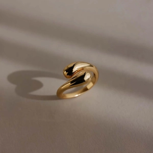 Elegant gold S925 sterling silver hug ring with polished teardrop ends in warm natural light