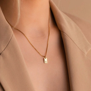 Minimalist gold S925 silver necklace with letter R pendant tag on a professional model